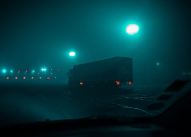 a car driving on a road at night