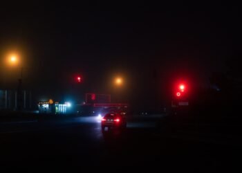 red car on road during night time